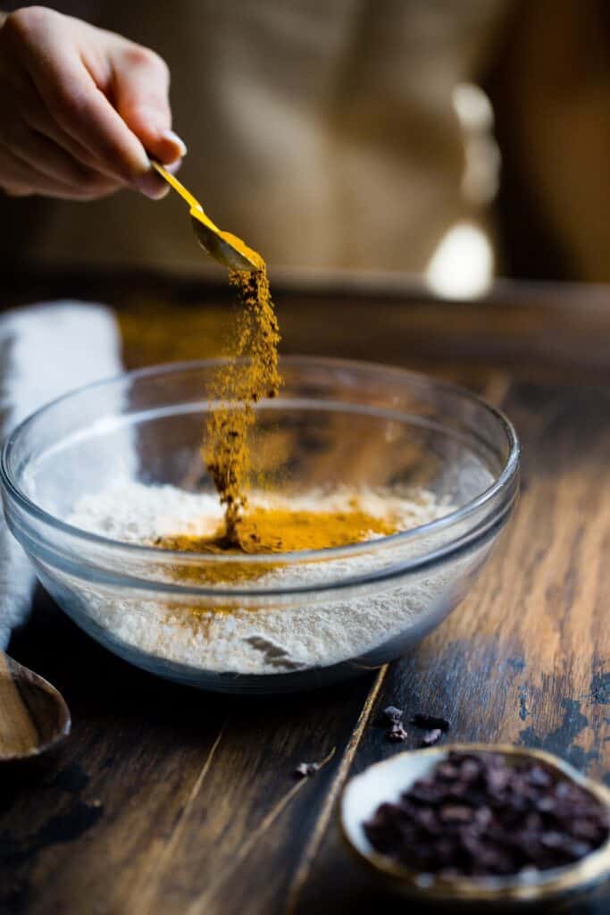 Adding spices to a scratch-prepared dish.  Preparing scratch food is a homesteading principle.  Photo by Taylor Kiser